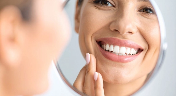 An even gum line framing the upper front teeth after gum reshaping
